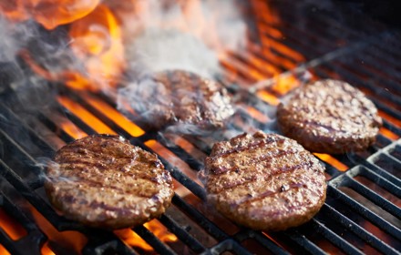 Cooked Burgers On A Grill.